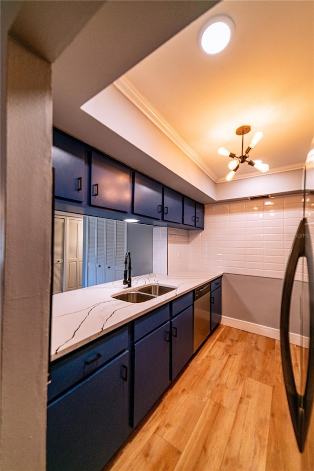 kitchen with blue cabinetry, dishwasher, sink, an inviting chandelier, and ornamental molding