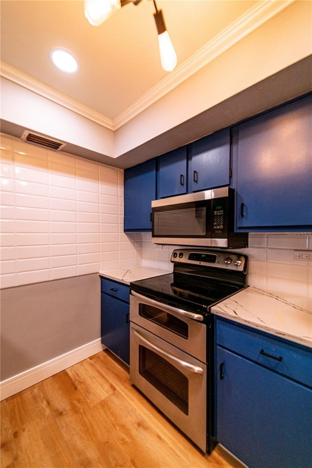 kitchen featuring backsplash, ornamental molding, blue cabinetry, appliances with stainless steel finishes, and light hardwood / wood-style floors