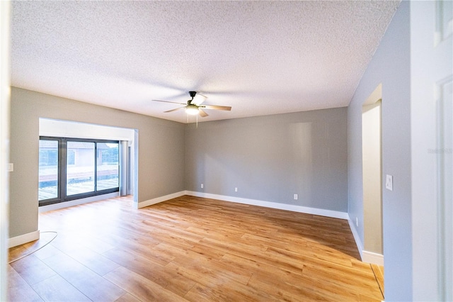 unfurnished room featuring ceiling fan, light hardwood / wood-style floors, and a textured ceiling