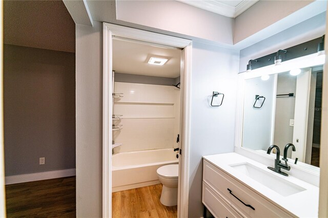 full bathroom featuring vanity, toilet, wood-type flooring, and bathtub / shower combination