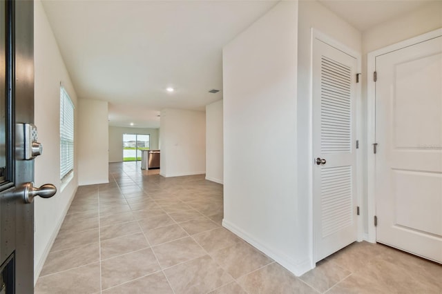 hallway with light tile patterned floors