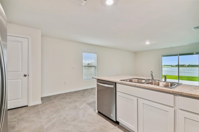 kitchen featuring dishwasher, a water view, white cabinetry, and sink