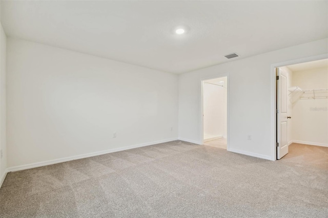 empty room featuring light carpet