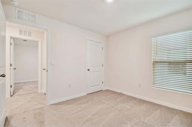 unfurnished bedroom featuring light colored carpet