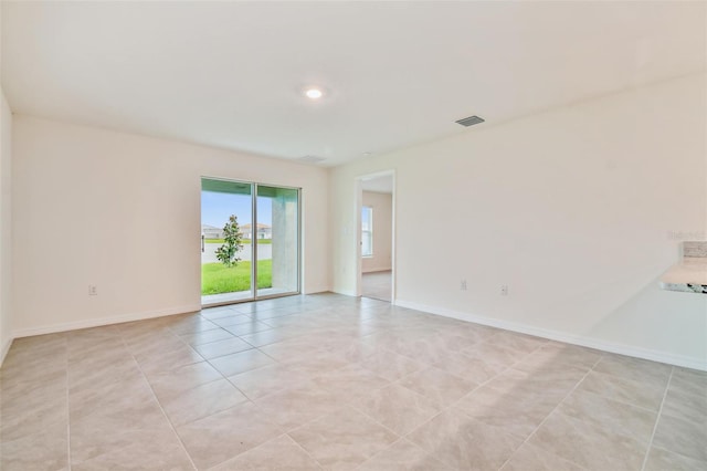 unfurnished room featuring light tile patterned flooring