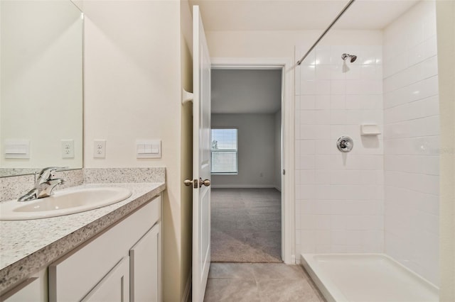 bathroom featuring tile patterned floors, vanity, and tiled shower