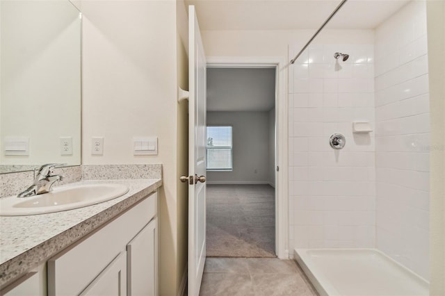 5552 Logan Cave Ave, Wimauma, FL 33598 - full bathroom with vanity, baseboards, tile patterned flooring, and tiled shower