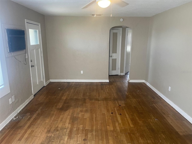 entryway with dark hardwood / wood-style floors, ceiling fan, and a wall mounted AC