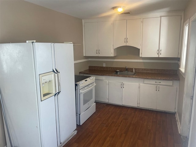 kitchen with white cabinets, dark hardwood / wood-style flooring, white appliances, and sink