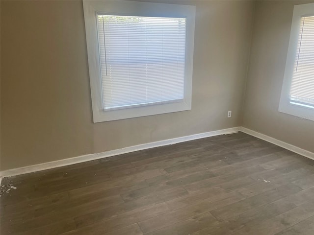 unfurnished room featuring dark wood-type flooring