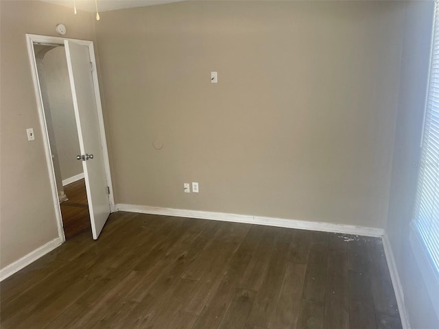 unfurnished room with dark hardwood / wood-style floors