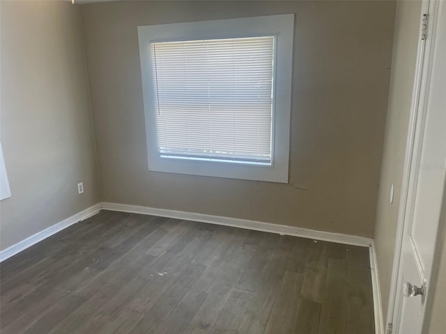 spare room featuring dark hardwood / wood-style flooring