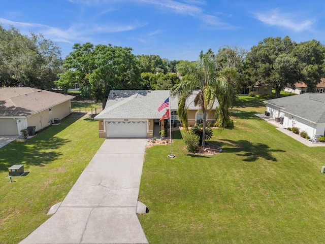 view of front of property featuring a garage and a front lawn