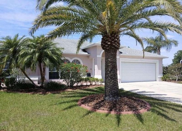 view of front of home with a garage and a front yard