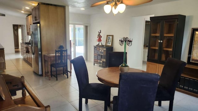 tiled dining space with ceiling fan