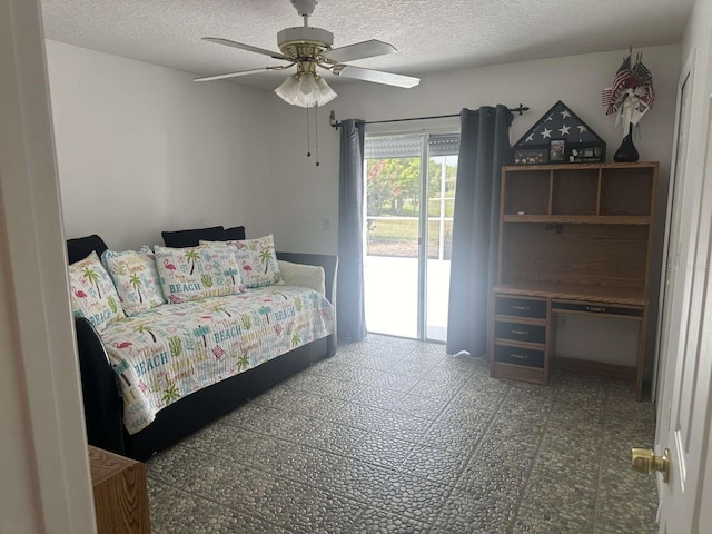 tiled bedroom featuring access to outside, a textured ceiling, and ceiling fan