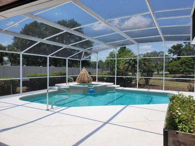 view of pool featuring glass enclosure and a patio area