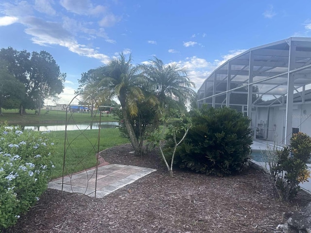 view of yard featuring a water view and a lanai