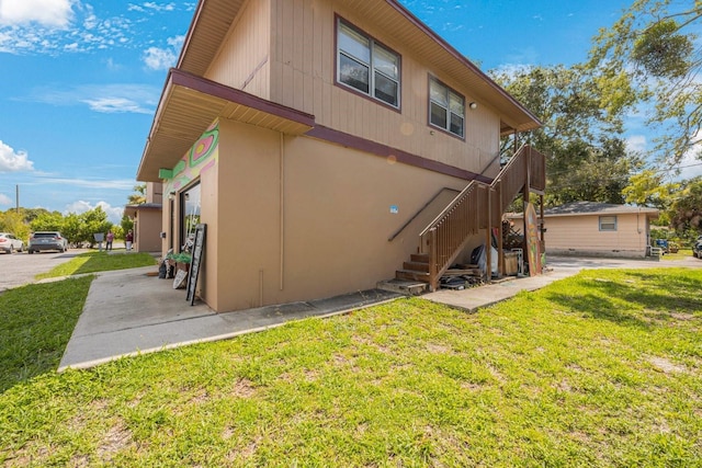 rear view of house featuring a yard