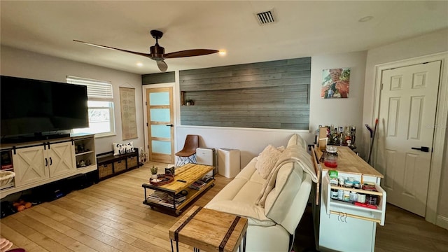 living room featuring ceiling fan and light wood-type flooring