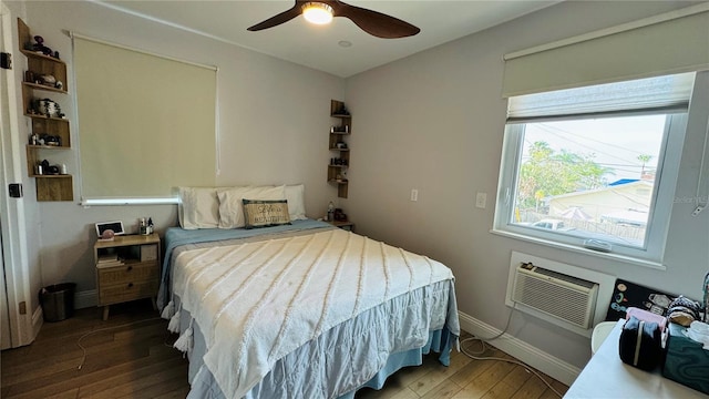 bedroom with ceiling fan, dark wood-type flooring, and a wall mounted AC