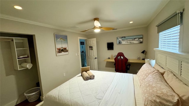 bedroom with ceiling fan, built in desk, and ornamental molding