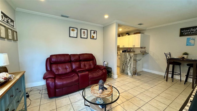 living room featuring ornamental molding and light tile patterned floors