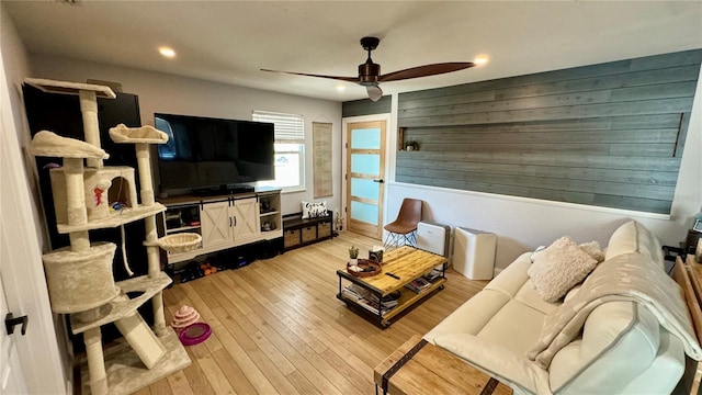 living room featuring ceiling fan and light hardwood / wood-style floors