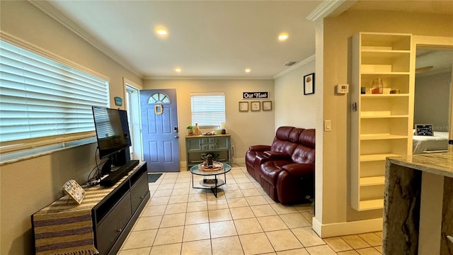 living room with light tile patterned floors and crown molding