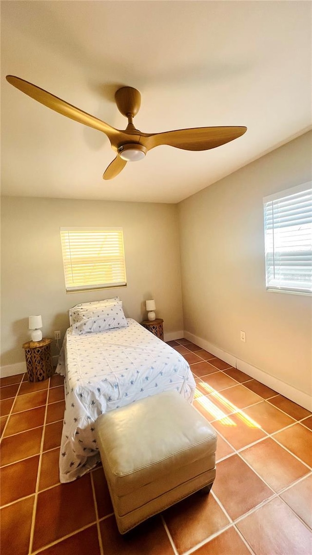 bedroom featuring ceiling fan and tile patterned flooring