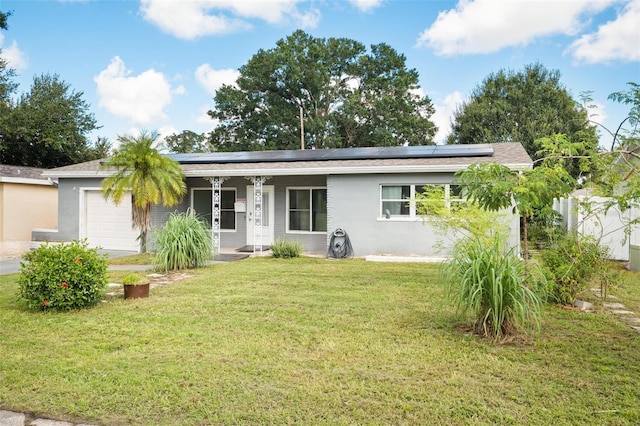 ranch-style home with solar panels, a porch, a front lawn, and a garage