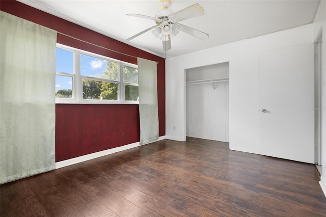 unfurnished bedroom featuring a closet, ceiling fan, and dark hardwood / wood-style floors