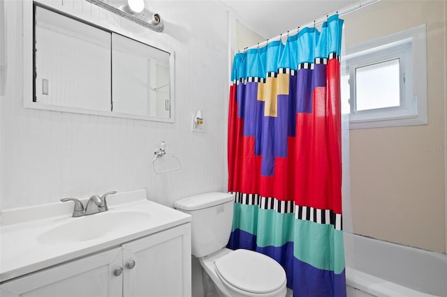 full bathroom featuring toilet, shower / bath combination with curtain, and vanity