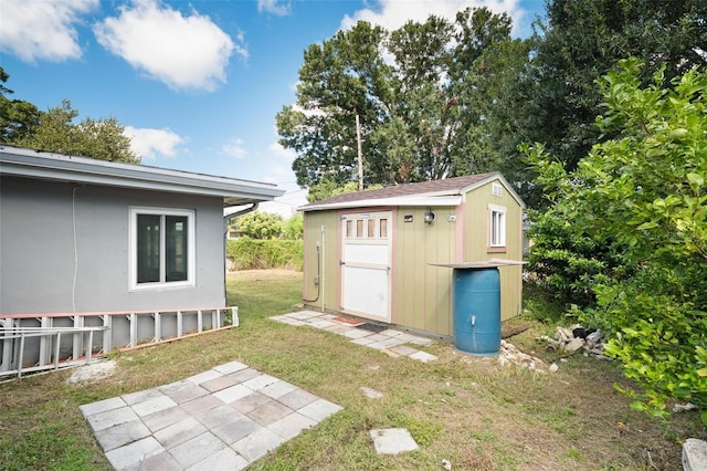 view of outbuilding featuring a lawn