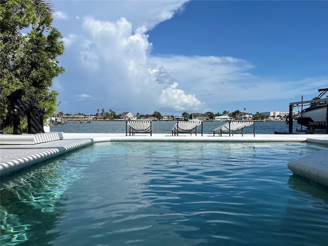 view of pool with a water view