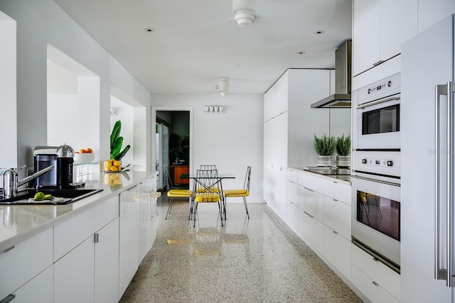 440 64th Ave, St Pete Beach, FL 33706 - kitchen featuring wall chimney exhaust hood, modern cabinets, dark speckled floor, and recessed lighting