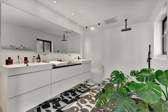 440 64th Ave, St Pete Beach, FL 33706 - bathroom with a shower, double vanity, and recessed lighting