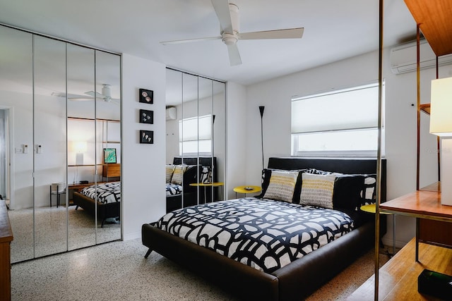 440 64th Ave, St Pete Beach, FL 33706 - bedroom featuring a wall unit AC, speckled floor, multiple windows, and ceiling fan