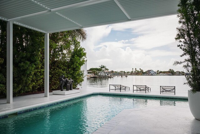 440 64th Ave, St Pete Beach, FL 33706 - swimming pool featuring a water view and a patio