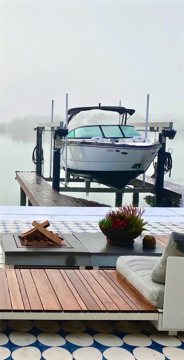 440 64th Ave, St Pete Beach, FL 33706 - dock featuring boat lift
