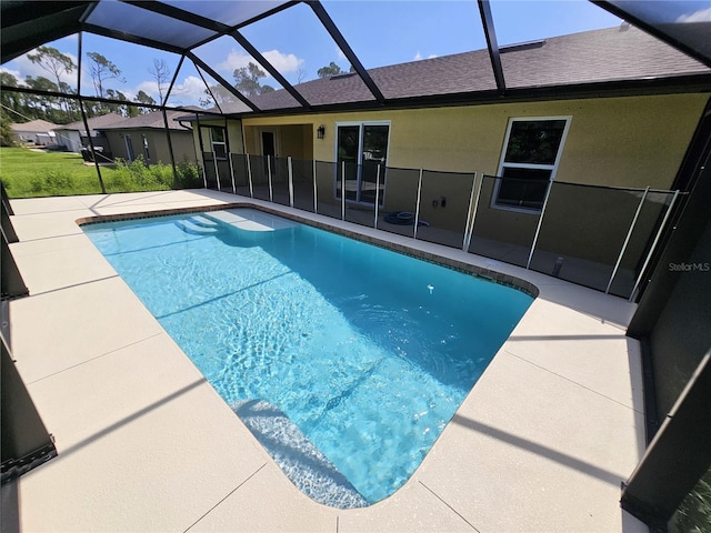 pool with a patio and glass enclosure