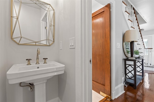 bathroom with hardwood / wood-style flooring and sink