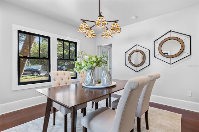 dining room with hardwood / wood-style flooring and a chandelier