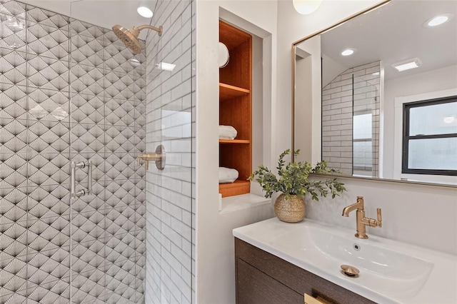 bathroom with vanity and a shower with shower door