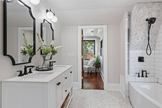 bathroom with tile patterned floors, vanity, and a tub