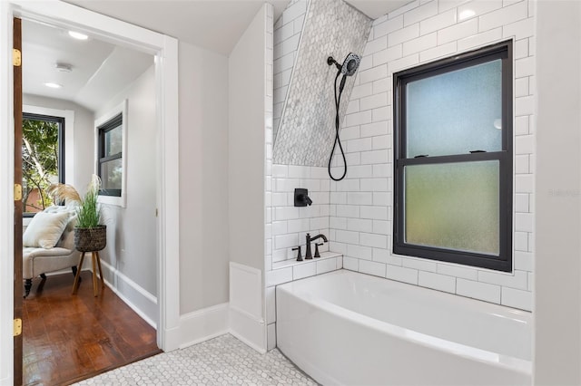 bathroom with tiled shower / bath combo and tile patterned floors