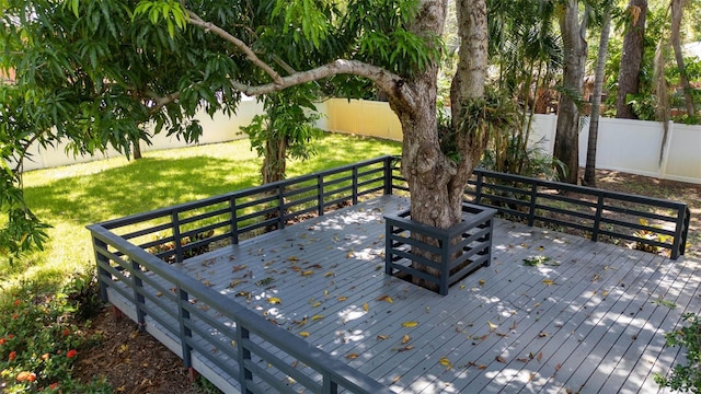 wooden deck with a lawn