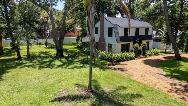 view of side of home featuring a yard