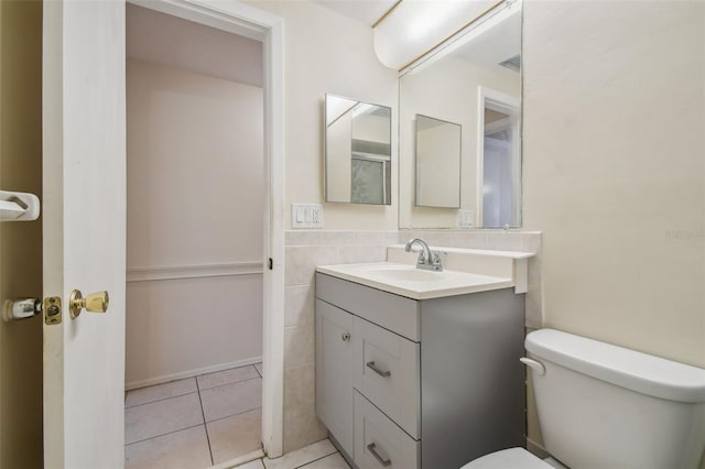 bathroom with tile patterned flooring, vanity, and toilet