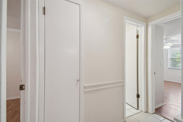 corridor featuring light tile patterned floors